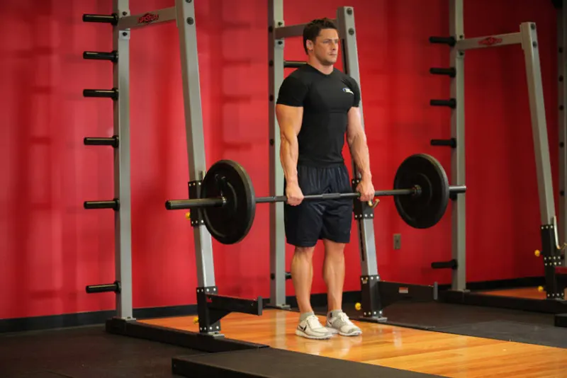 Shrugs met barbell